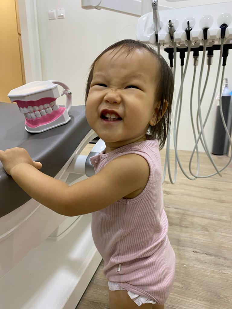 Happy 1-year-old child at just kids dental clinic singapore.