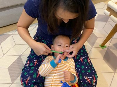 Brushing baby teeth - preparing for the first dental visit at just kids dental clinic